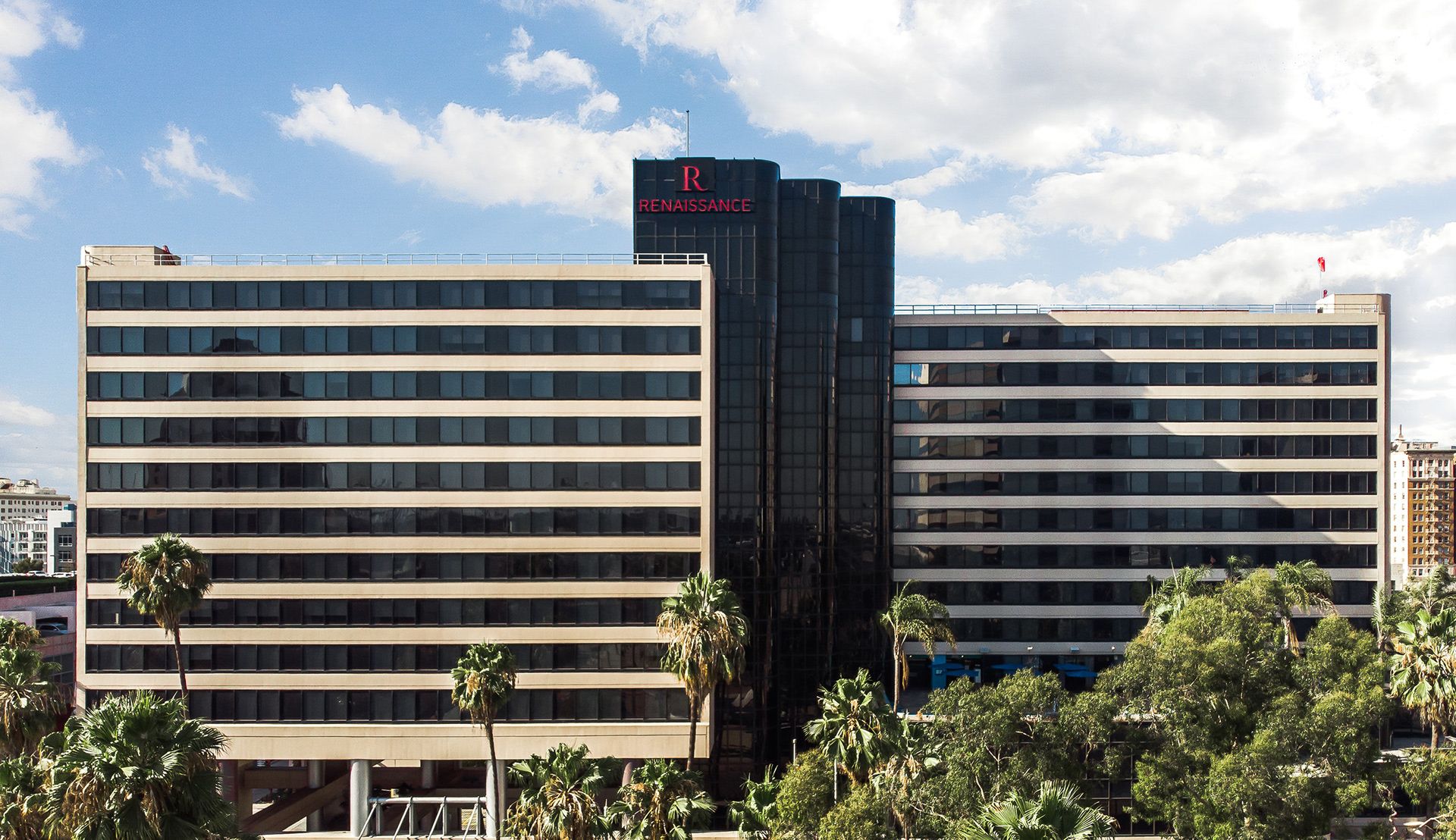 Renaissance hotel exterior in Los Angeles under a bright sky with palm trees